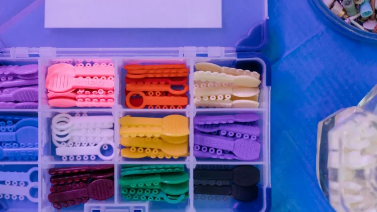 Close-up view of colorful orthodontic elastics arranged in a dental equipment box.