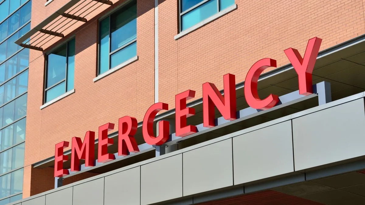 Close-up of a modern hospital emergency room entrance with prominent red letters.