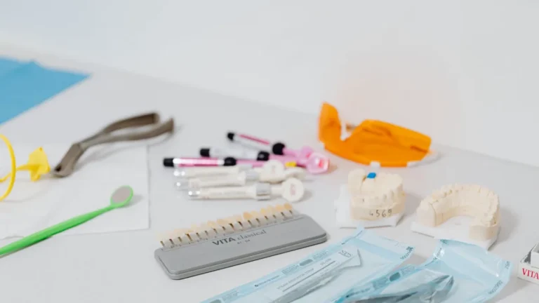 Close-up of various dental tools and models used for dentistry displayed on a table.