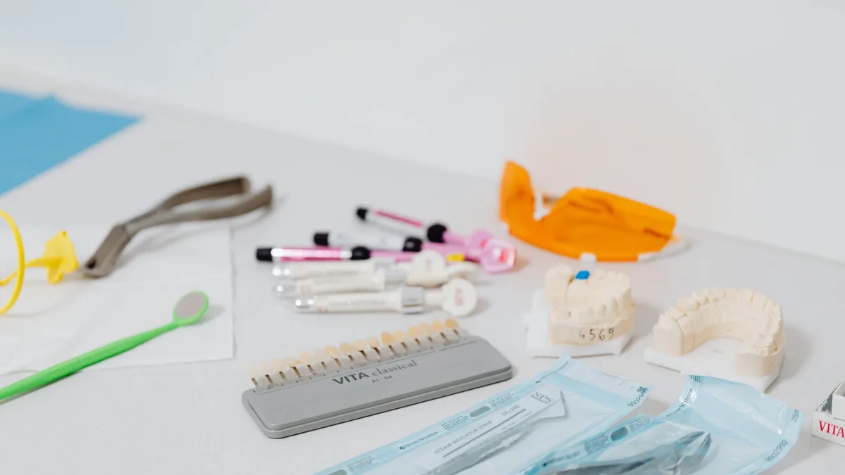 Close-up of various dental tools and models used for dentistry displayed on a table.
